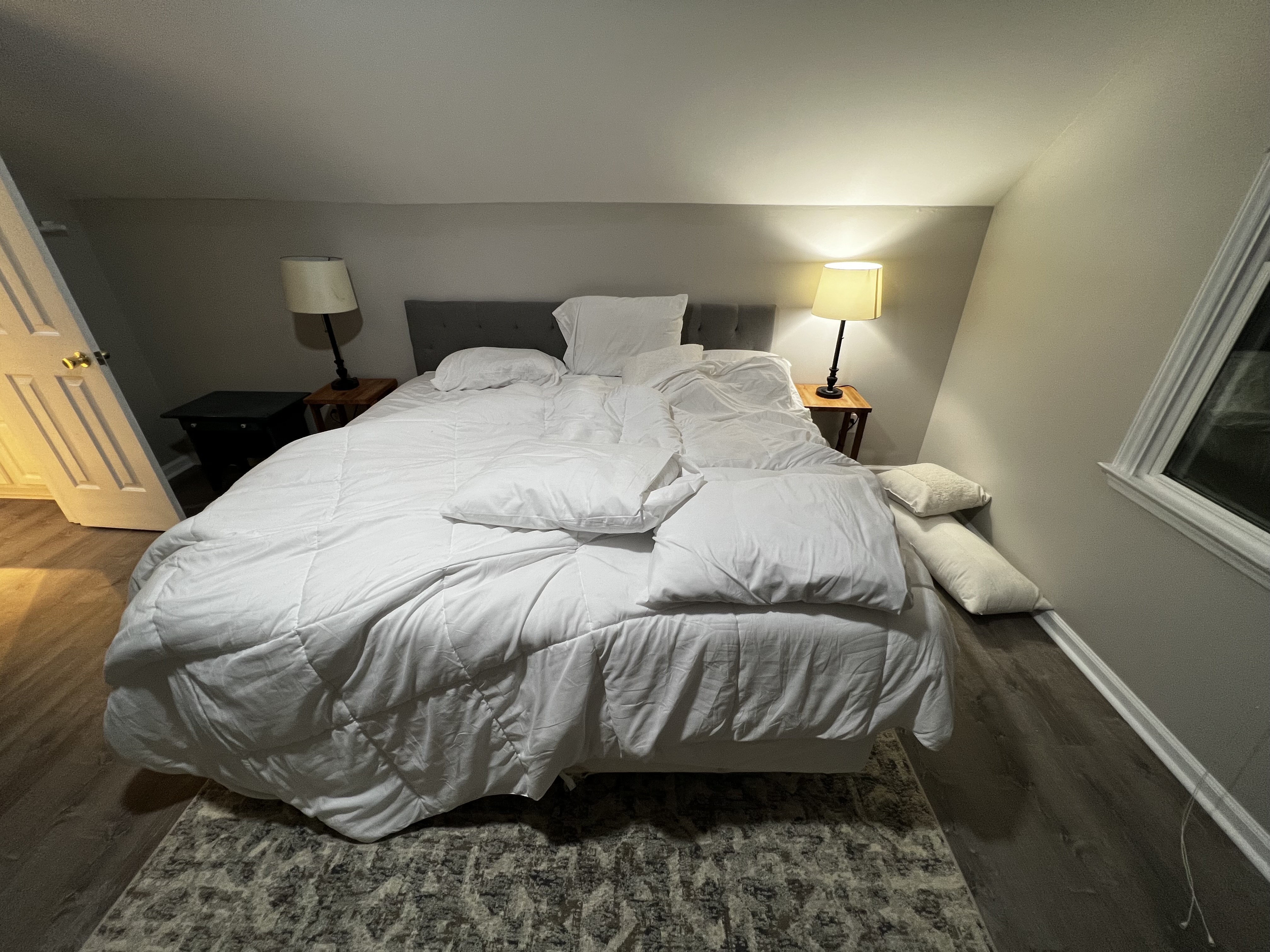 Official input: an unmade bed with loose white bedding and pillows